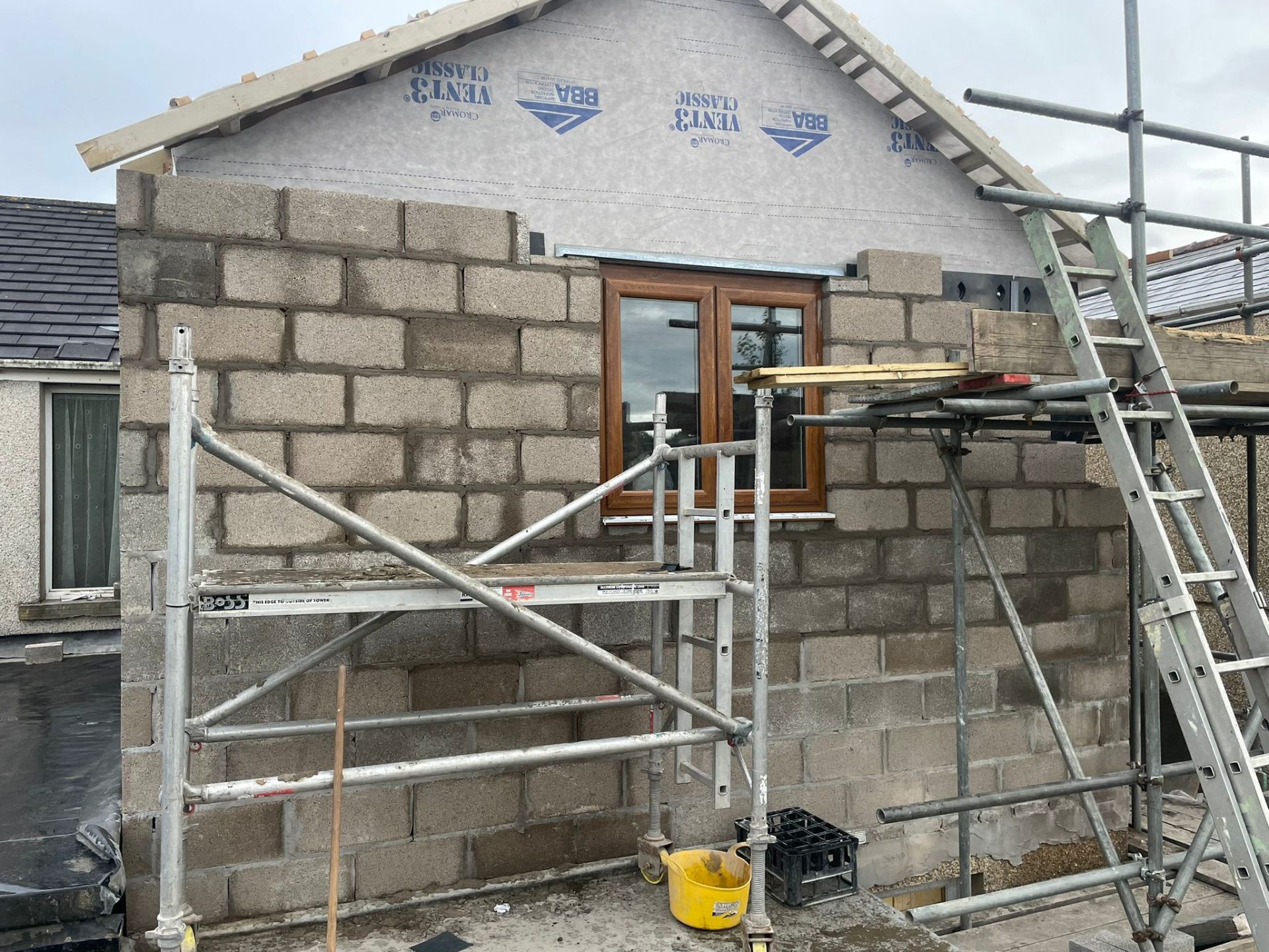 New build blockwork gable end with window and scaffolding in Tredegar