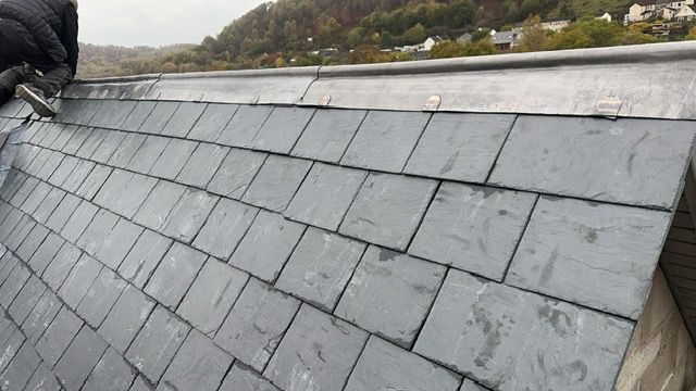 Slate ridge tile detail on a completed roofing project in South Wales
